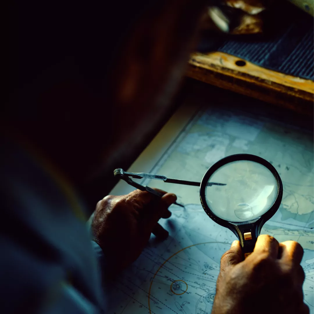 Image of a ship captain charting a course.