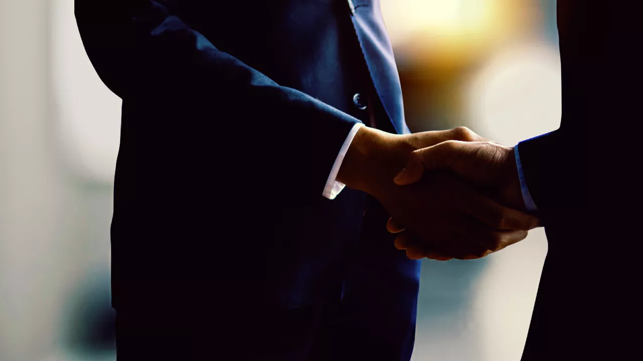 Image of two people shaking hands.
