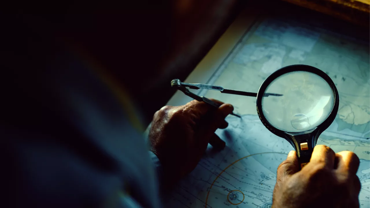 Image of a ship captain charting a course.