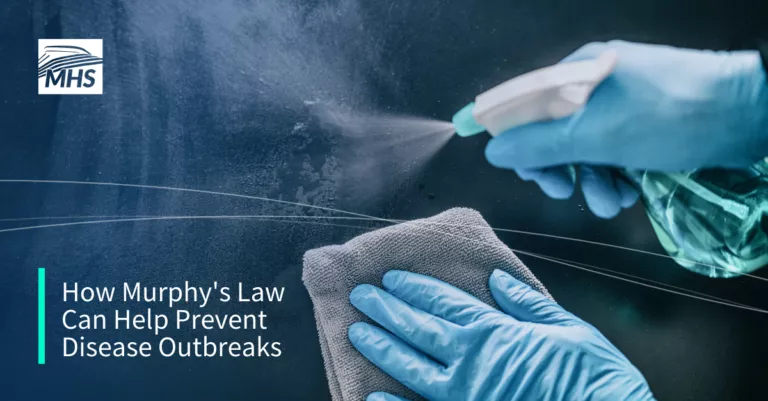 Photo of gloved hands sanitizing a surface, with the words, How Murphys Law Can Help Prevent Disease Outbreak.