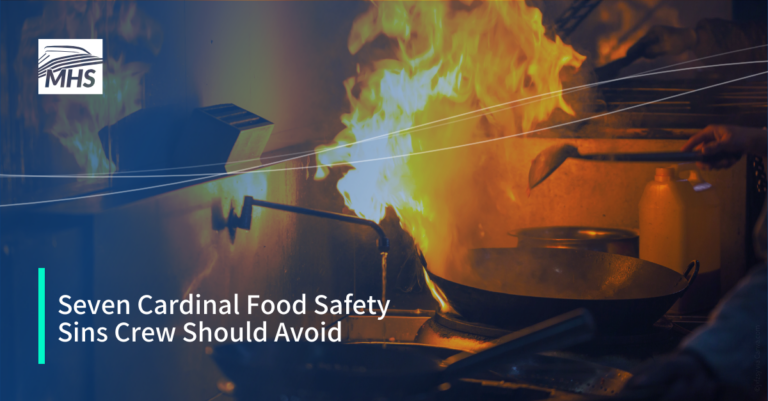 A professional kitchen with a frying pan on fire, with the words, Seven Cardinal Food Safety Sins Crew Should Avoid