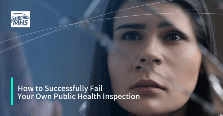 A closeup of a young woman looking at her own reflection in a broken mirror with the words, How to Successfully Fail Your Own Public Health Inspection